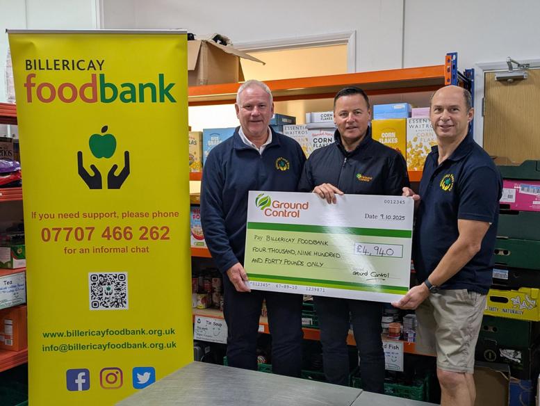 Ground Control's Darren Daley presented a large cheque to the foodbank. Handing this over to two repsentatives.