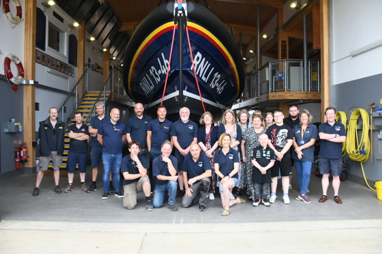 Photo of attendees in front of an RNLI lifeboat